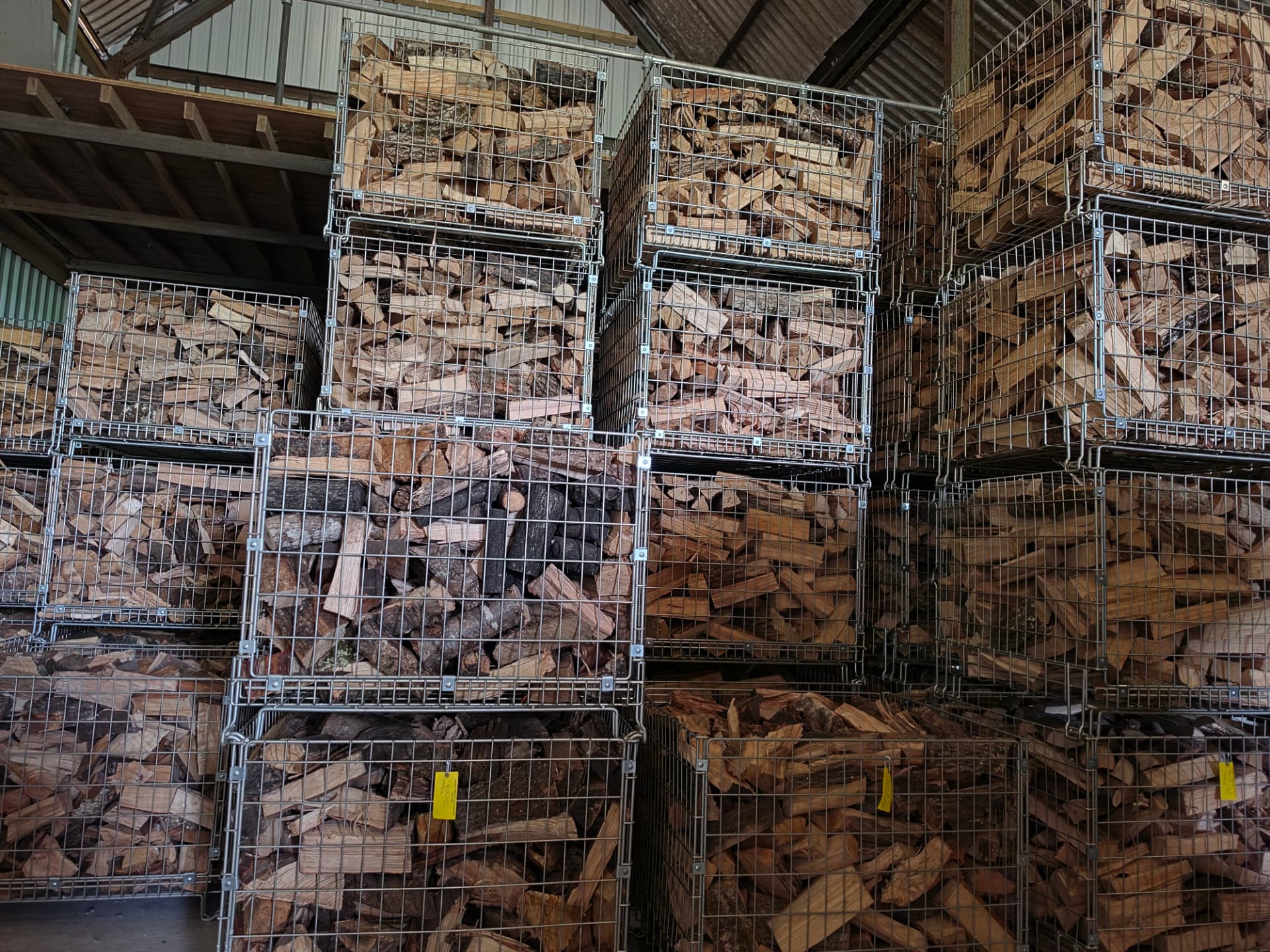 Crates of seasoned hardwood logs stacked in the barn at Manor Farm